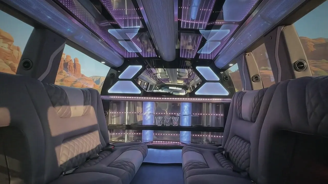 Inside the Cadillac Escalade limo in Manitou Springs: LED light-show ceiling, leather lounge seating and lit bar